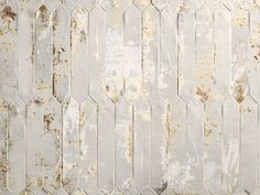 an old white tile wall with rusted paint on the bottom and sides, as well as some brown spots