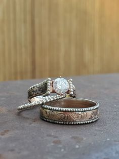 two wedding rings sitting on top of each other