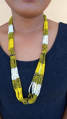 African beaded necklace, Layered necklace, Multi strand necklace, African jewelry, Masai necklace, Women necklace, Gift for herThis stunning necklace is superbly crafted.The necklace can be worn with any outfit at different occasions and it will absolutely make you stand out.Color: Black,Yellow & White.3-5 days delivery via DHL ExpressThe shipping fee is for the first item only and additional necklaces or items ship for free.Wholesale available at a fair price,please contact me.For any clari Yellow Beaded Long Necklace, Traditional White Single Strand Beaded Necklace, Yellow Single Strand Beaded Necklace As Gift, Yellow Necklace With 108 Beads As Gift, Masai Necklace, African Beaded Bracelets, African Beaded Necklace, African Beads Necklace, Cowrie Shell Necklace