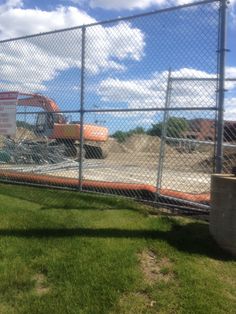 a construction site behind a chain link fence