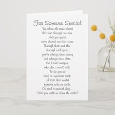 a card with a poem on it sitting next to a vase filled with yellow flowers