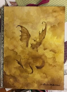 a book with an image of a dragon flying through the sky on it's cover