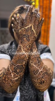 a woman with her hands covered in henna