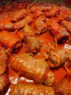 meatballs and sauce in a pan with toothpicks sticking out of the top