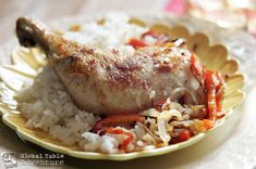 a close up of a plate of food with rice and meat on it's side