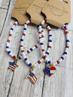 Get your one-of-a-kind, pretty, little thing from Doohickies & Such.  Sign up for the VIP newsletter to get insider news before anyone else! http://eepurl.com/hdVZk9  Choose between a USA Flag, USA Heart, or USA star beaded bracelet. Each bracelet has a mix of red, white and blue seed beads. Accents of gold beads are used too. This is a great summer piece. Measuring 7.25" and is stretchy, made with double 0.5mm stretch cord.   Made with love and from a smoke free home. WEAR AND CARE: No piece should be submerged in water for these are not made with real gold or silver. Try and avoid harsh chemicals when wearing your jewelry piece (i.e. cleaners, perfume and lotions). This item is handmade with love, so please try to not stretch or tug at the pieces so they can keep their shape. Follow me o Star Beaded Bracelet, Patriotic Bracelet, Flag Bracelet, Beads Art, Blue Beaded Bracelets, African Beads, Usa Flag, Bead Art, Red White And Blue