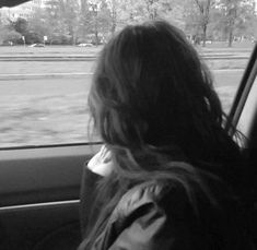 a woman sitting in the back seat of a car