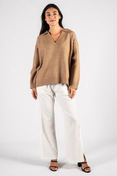 A top that both looks good and keeps you cozy. This sweater top is ready for fall. Details: - Collared - Long sleeve - V neck - Ribbed knit Oversized Casual V-neck Sweater For Loungewear, Knit V-neck Sweater For Fall Layering, Chic V-neck Knit Polo Sweater, Knit V-neck Sweater With Ribbed Collar For Fall, Chic Relaxed Fit V-neck Sweater With Long Sleeves, Casual Knit V-neck Sweater For Work, Casual V-neck Sweater With Ribbed Collar For Fall, Trendy V-neck Sweater For Fall Workwear, Beige V-neck Sweater For Fall Loungewear