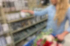 a blurry photo of a woman in a store aisle pointing at items on shelves