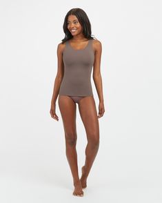 Your go-to essential and everyday layering piece, our SPANXsmooth™ Socialight Tank delivers lightweight compression for all-day wear. A tank top made from super-soft microfiber that's comfortable, breathable and quick-drying, and engineered with no-dig adjustable straps, it's the perfect smoothing shapewear base underneath any of your tops. | Spanx Women's SPANXsmooth Socialight Tank Top Supportive Seamless Solid Tank Top, Solid Supportive Seamless Tank Top, Supportive Seamless Solid Color Tank Top, Seamless Compression Tank Top, Seamless Sleeveless Shapewear Activewear, Versatile Compressive Seamless Tank Top, Versatile Seamless Compressive Tank Top, Full Coverage Fitted Top With Soft Touch, Fitted Full Coverage Top With Soft Touch