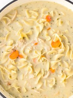 a pot filled with chicken noodle soup on top of a table