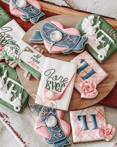 decorated cookies are arranged on a wooden platter