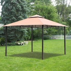 a gazebo sitting on top of a lush green field