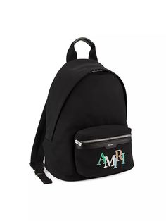 Crafted in Italy, Amiri's backpack features a vibrant staggered logo on the front pocket. Logo-engraved silvertone hardware adds the finishing touch..Top handle.Adjustable backpack straps.Zip-around closure.One main compartment.Front zip pocket.Polyester.Trim: Bovine leather.Lining: nylon.Made in Italy.ABOUT THE BRAND.Designer and California native Mike Amiri got his start making handcrafted pieces for rockstars to wear on stage. He brings the same L.A. rocker aesthetic to his eponymous label, w Luxury School Backpack With Logo, Designer Backpack With Logo For Daily Use, Modern Everyday Backpack With Logo, Designer Backpack With Logo For Everyday Use, Designer Logo Backpack For Everyday Use, Deconstructed Jeans, Rocker Aesthetic, Mike Amiri, Pocket Logo