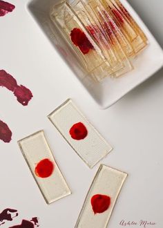 some food on a white table with red and pink paint splattered around it