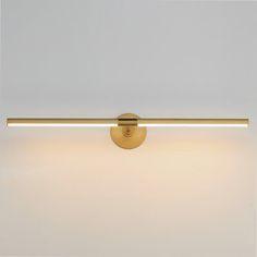 an image of a bathroom light that is on the wall in front of white walls