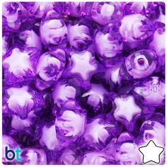 purple glass beads with white stars on the top and bottom are shown in close up