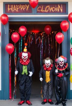 two clowns are standing in front of a doorway with balloons