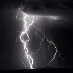 a black and white photo of lightning in the sky