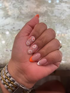 summer nails #flowers #orange #almondnails Summery Flowery Nails, Pastel Orange Nails With Flowers, Orange Nails White Flowers, Orange And Flower Nails, Almond Nails Orange French Tip, Orange Nails Acrylic Square, White And Orange French Tip Nails, White Tips With Flowers Nails, Summer French Tips With Flowers