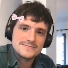 a man wearing headphones and a bow tie