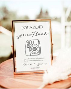 a polaroid guest book on a wooden table