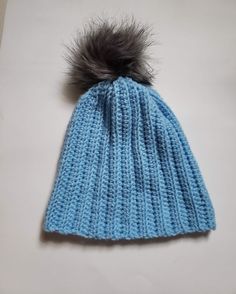 Light blue handmade crochet hat with grey faux fur pompom. Acrylic yarn. Label affixed inside. Can be worn cuffed or uncuffed. Blue Crochet Hat, Yarn Label, Light Blue Crochet, Teal Hat, Blue Crochet, Crochet Beanie, Skull Cap Beanie, Crochet Hat, Skull Cap