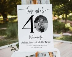 an easel with a sign that says forty whos welcome to someone's 10th birthday