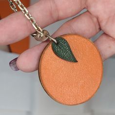 This Is An Authentic Hermes Chevre Mysore Orange Key Chain Bag Charm In Orange. This Delightful Keychain Or Bag Charm Has A Silver Chain Link Loop And A Textured Goatskin Leather Orange Fruit In Orange And A Miniature Small Leaf (Stamped Hermes) For Detail With The Stylish Sophistication Of Hermes! Includes Authentic Hermes Box. Measurements: Orange: 1 3/8" Long 1 3/4" Wide 1/8" Thick Leaf: 7/8" Long 7/16" Wide Chain, Clasped: With Bail & Clasp: 2 3/4" Without Bail & Clasp: 2" Box: 6" X 6" X 1.2 Hermes Orange, Hermes Accessories, Hermes Box, Orange Fruit, Small Leaf, Mysore, Orange Leather, Chain Bag, Chain Bags