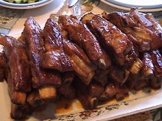 ribs and potatoes are piled on a plate