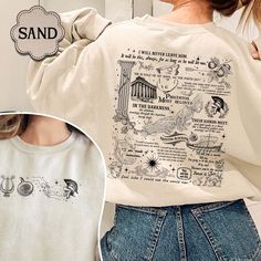 the back of a woman's sweatshirt with an image of buildings and other things on it