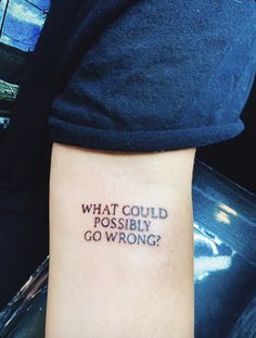 a person with a tattoo on their arm that says, what could possibly go wrong?