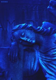 a statue is shown with blue light in the background and it looks like he has fallen asleep