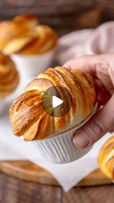 a person holding a croissant in their hand