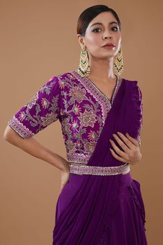 Purple can can attached draped lehenga saree in layered silhouette embellished by sequins and border frill detail. Comes with padded thread floral embroidered blouse and sequin embellished belt. - Aza Fashions Elegant V-neck Choli With Resham Embroidery, Elegant V-neck Lehenga With Resham Embroidery, Elegant V-neck Lehenga With Zari Work, Fitted Silk V-neck Set, Festive V-neck Georgette Blouse Piece, Festive V-neck Lehenga With Dupatta, Elegant V-neck Traditional Wear With Pallu, V-neck Wedding Blouse With Intricate Embroidery, Designer V-neck Choli With Resham Embroidery