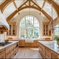 a large kitchen with an arched ceiling and wooden cabinets