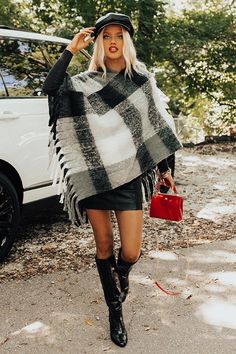 Make a cozy debut this fall with this chic charcoal colored poncho featuring ultra soft material patterned with a black and white plaid print, a high v-cut neckline, draped 3/4-length sleeves with open cuffs, and a relaxed silhouette that falls into a pointed mid-thigh length hemline with fringe trim detailing! Oversized Gray Poncho For Fall, Cozy Gray Poncho For Fall, Oversized Plaid Poncho For Fall, Plaid Long Sleeve Poncho For Fall, Plaid Poncho Outfit, Poncho Outfit Fall, Poncho Outfit, Fall Fashion Trends Women, Plaid Poncho