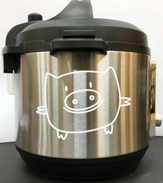 a stainless steel crock pot with a pig drawn on it