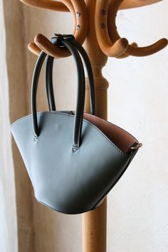 Genuine Mango Vegan leather bucket bag in deep evergreen.

This purse features a structured exterior body with zip closure cotton interior compartment.

Can be carried as a handbag or worn as a shoulder or crossbody with the included strap!

Like new condition. There is minor wear on d-ring hardware where the optional strap attaches. Leather Crossbody Bags, Leather Bucket Bag, Leather Bucket, Women Bag, D Ring, Leather Goods, Canvas Bag, Leather Crossbody Bag, Leather Crossbody