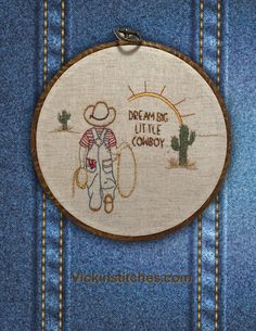 a cross stitch pattern with a cowboy holding a lasso and the words dream big little cowboy on it