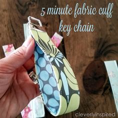 a hand holding a tie with the words 5 minute fabric cuff key chain on it