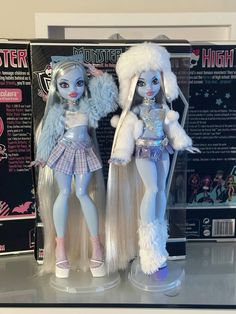 two monster dolls standing next to each other