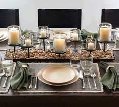 a table set with place settings and candles