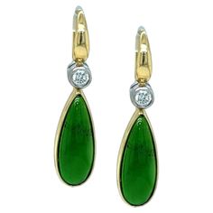 These lovely earrings feature a pair of beautiful chrome diopside cabochons set in 18k yellow gold bezels, dangling below sparkling diamonds set in white gold bezels. Fine quality chrome diopside is a rich, vivid green color and it is luxuriously translucent. It resembles "Imperial" jade, at a fraction of the cost! With a French wire back, the front of which has rounded, tapering lines that create flowing continuity of design, these earrings are elegant and sophisticated, yet understated enough for daytime wear! Handmade in 18k white and yellow gold by our Master Jewelers in Los Angeles. Just beautiful! Earrings measure approximately 1 inch from the top of the diamond to the bottom of the chrome diopside. Chrome diopside cabochons, 18.00 x 8.00mm, 8.26 carats total Diamonds, 4.50mm, .90 ca Luxury Cabochon Dangle Earrings, Pretty Earrings Dangle, Imperial Jade, Diamond Dangle Earrings, French Wire, Antique Earrings, Lovely Earrings, Gold Earrings Dangle, Yellow Diamond