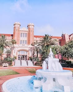 a large building with a fountain in front of it