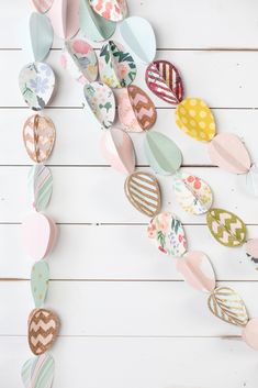 paper hearts hanging from the ceiling on a white wooden background with text overlay that says diy valentine's day decorations