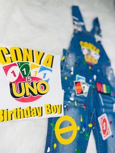 a pair of denim overalls with stickers on them and a birthday boy t - shirt