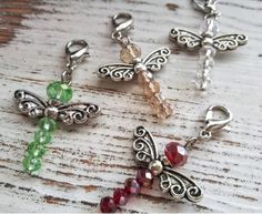 four charms with different colors and designs on them