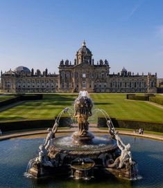 a large building with a fountain in front of it