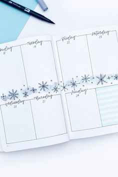 an open planner with snowflakes on it